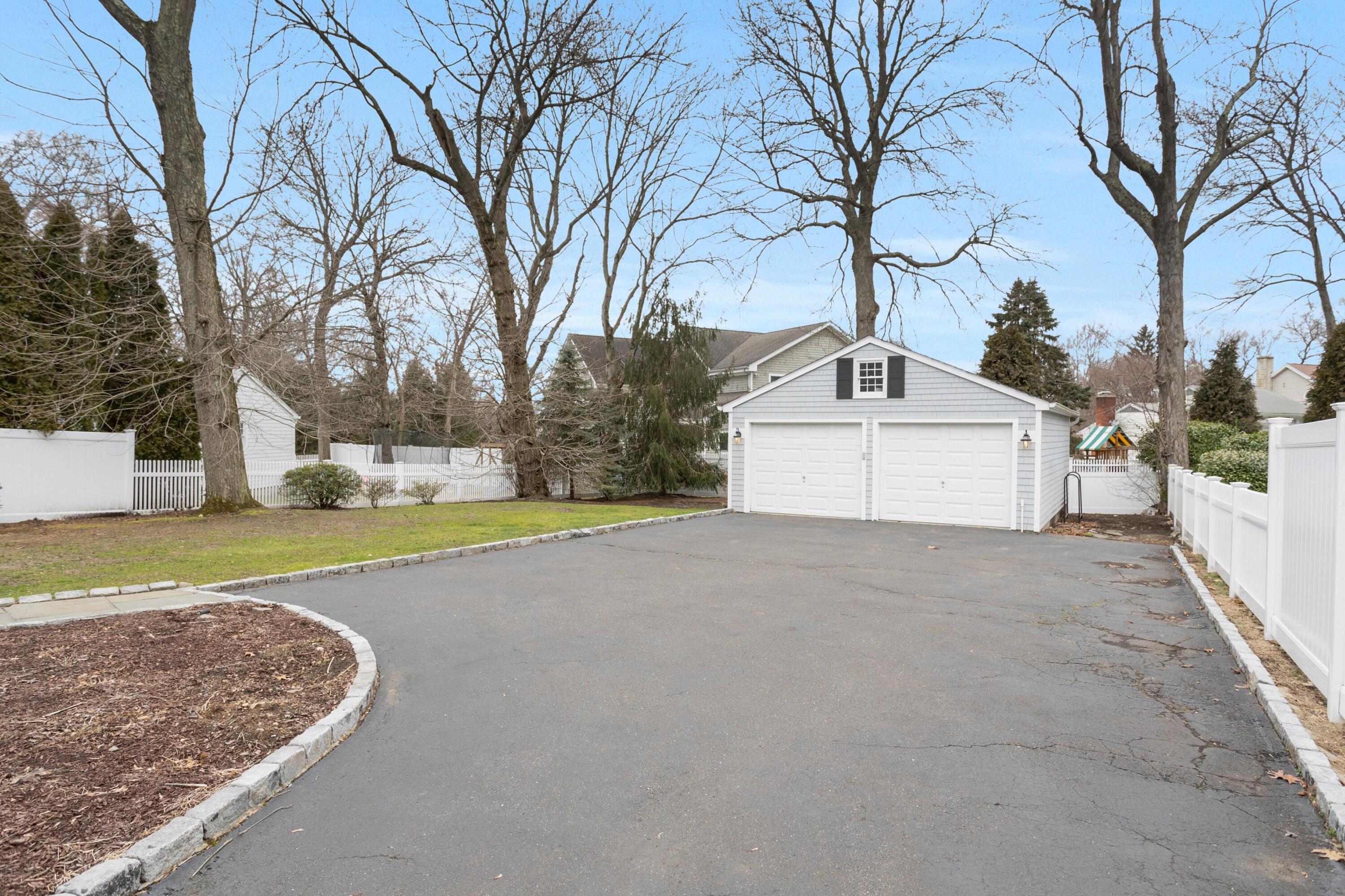 103 Hollow Tree Ridge Road Darien, CT 06820 - Photo 30 of 35 a view of a house with a yard covered with snow in the background