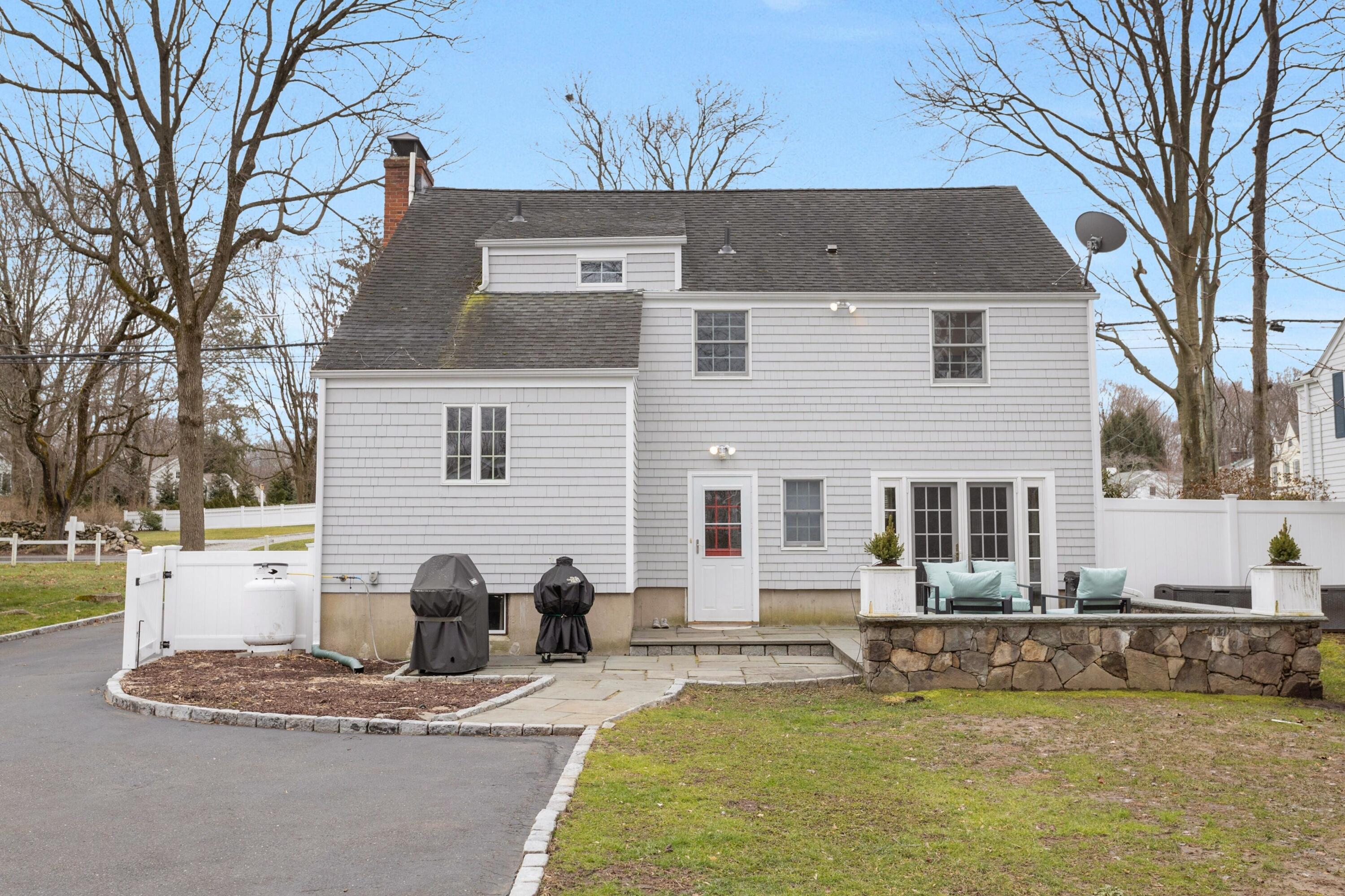 103 Hollow Tree Ridge Road Darien, CT 06820 - Photo 32 of 35 a front view of a house with a yard and couches