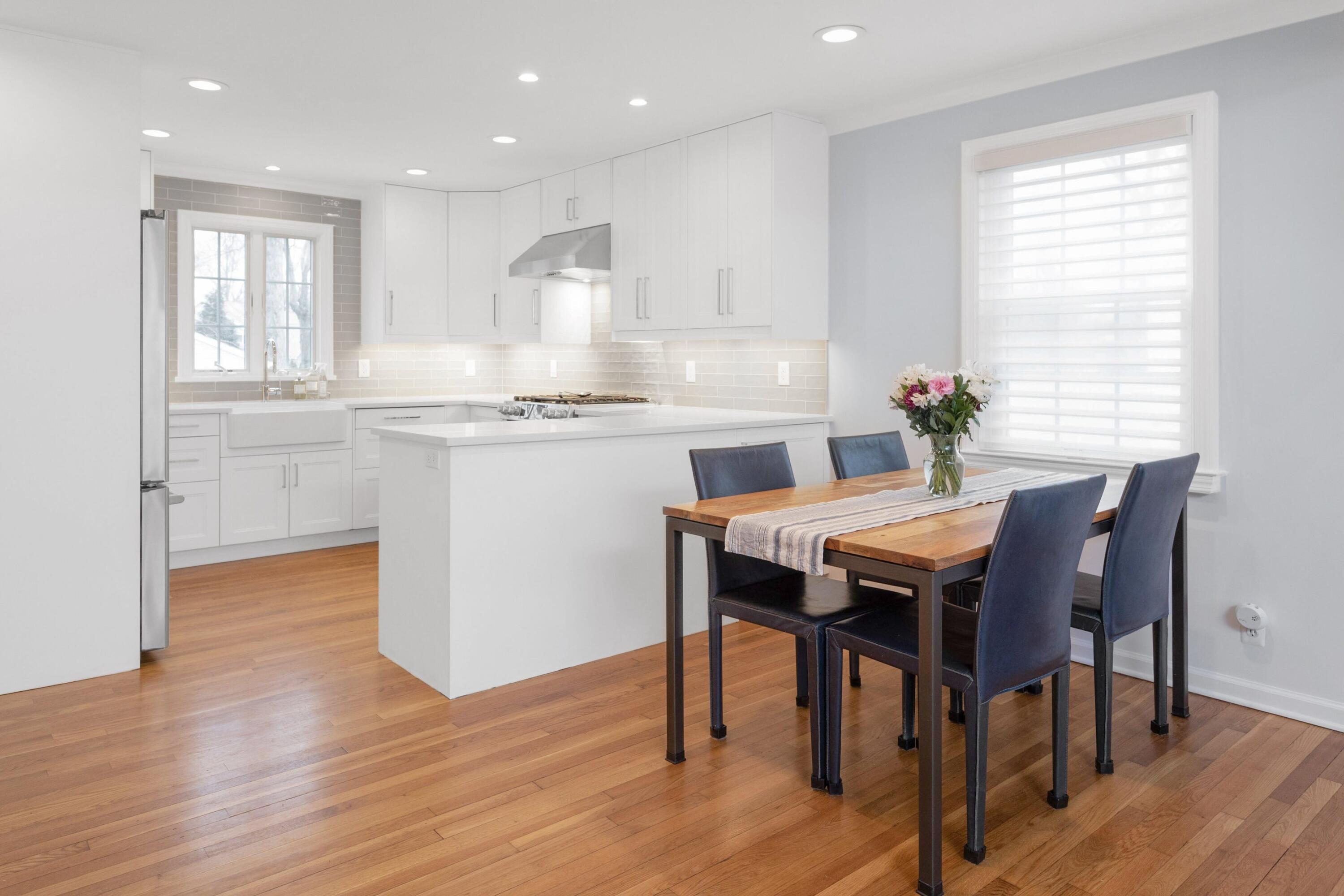 103 Hollow Tree Ridge Road Darien, CT 06820 - Photo 8 of 35 a kitchen with stainless steel appliances granite countertop a stove a sink a refrigerator dining table and chairs