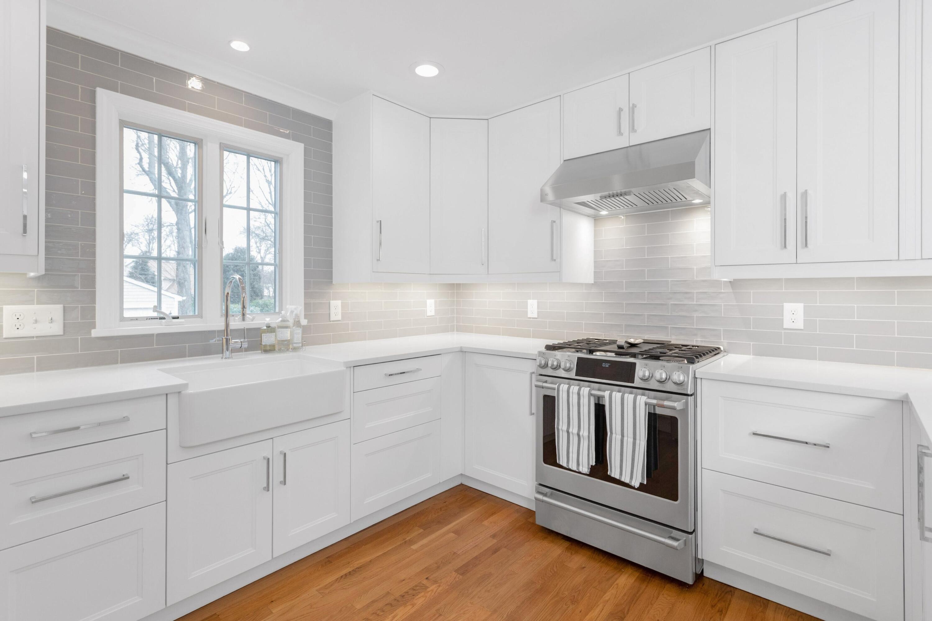 103 Hollow Tree Ridge Road Darien, CT 06820 - Photo 10 of 35 a kitchen with white cabinets and a stove