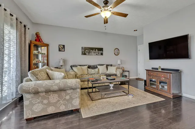 a living room with furniture and a flat screen tv