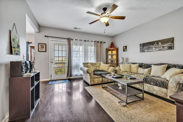 a living room with furniture a large window and a flat screen tv