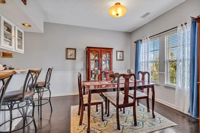 a view of a dining room with furniture and wooden floor