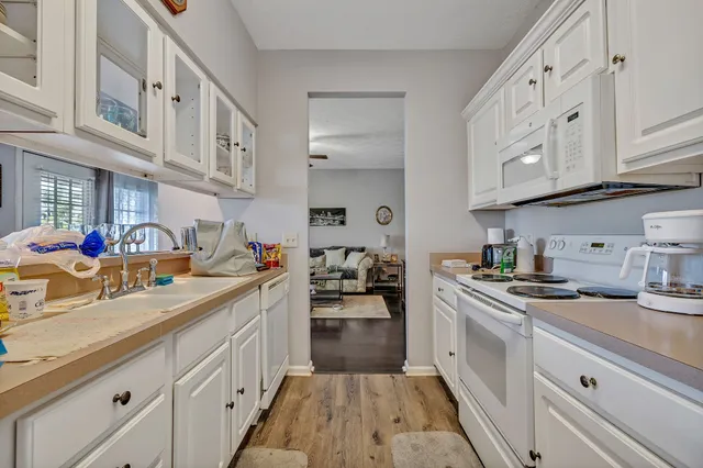 a kitchen with cabinets a sink and appliances