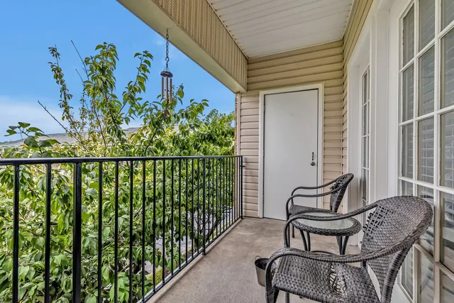 a view of a chair and table in the balcony