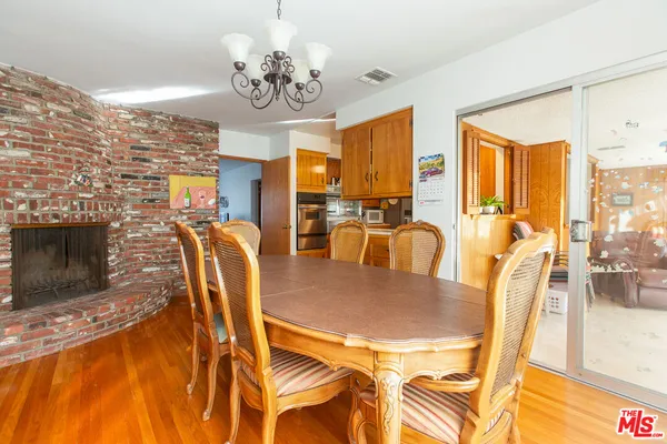 a large kitchen with stainless steel appliances a sink and cabinets