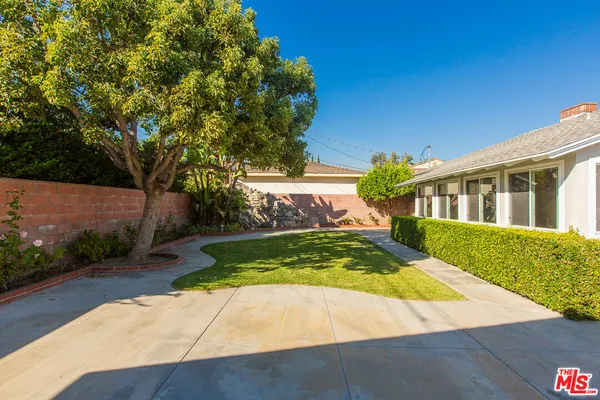 a vase of flowers sitting on a wooden floor