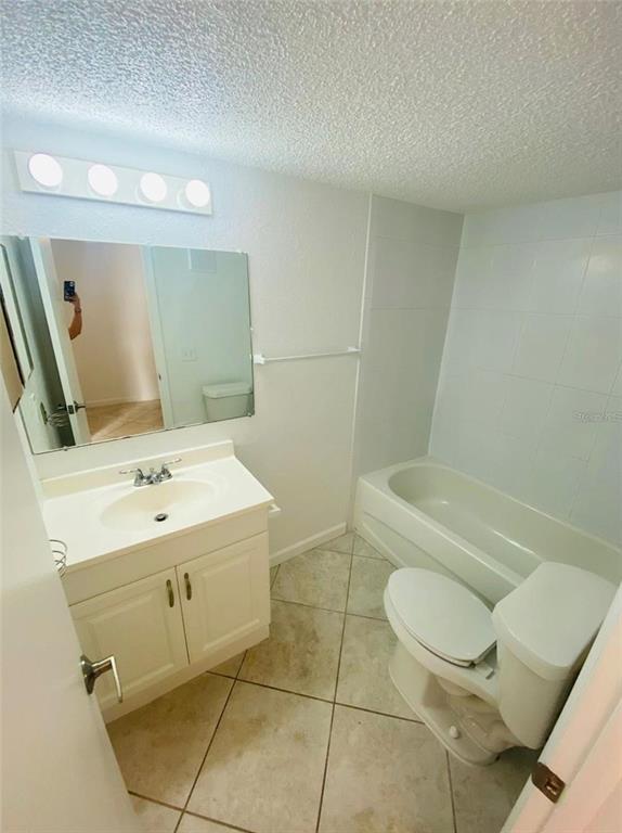 633 North Keene Road, Unit C Clearwater, FL 33755 - Photo 15 of 20 a bathroom with a sink a toilet and mirror
