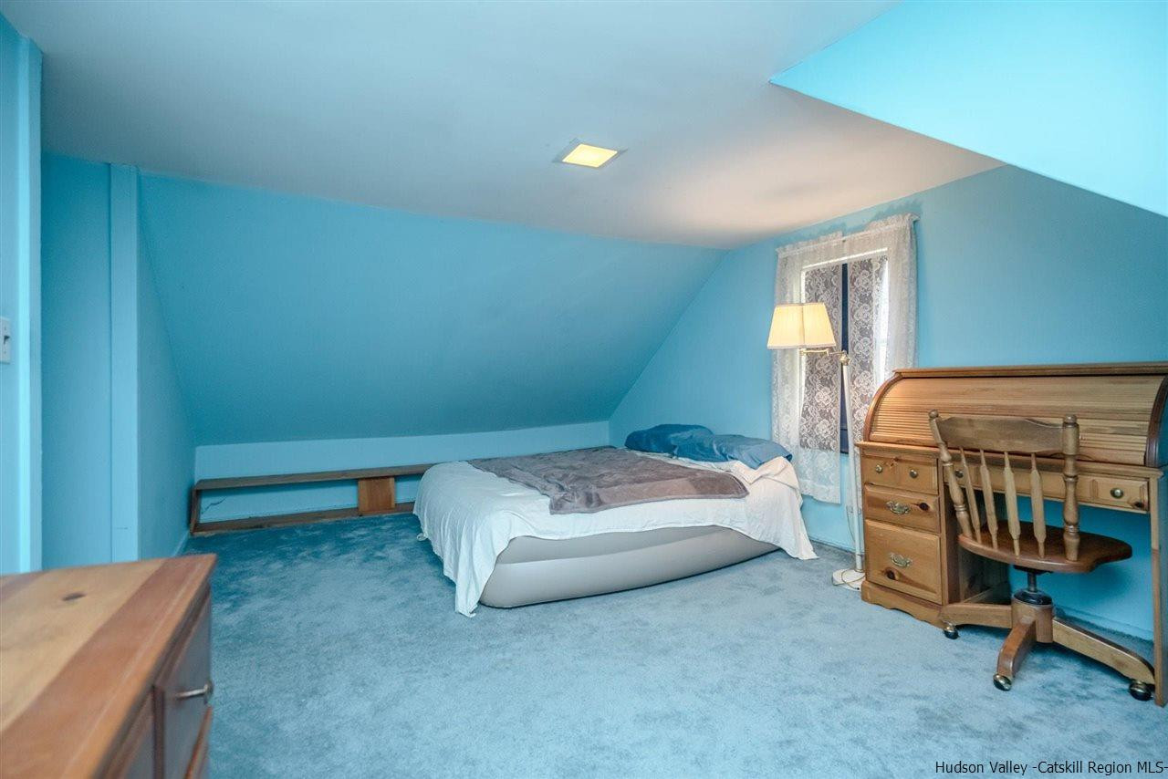 1034 Pine Place Kingston, NY 12401 - Photo 15 of 22 a bedroom with a bed and a chair