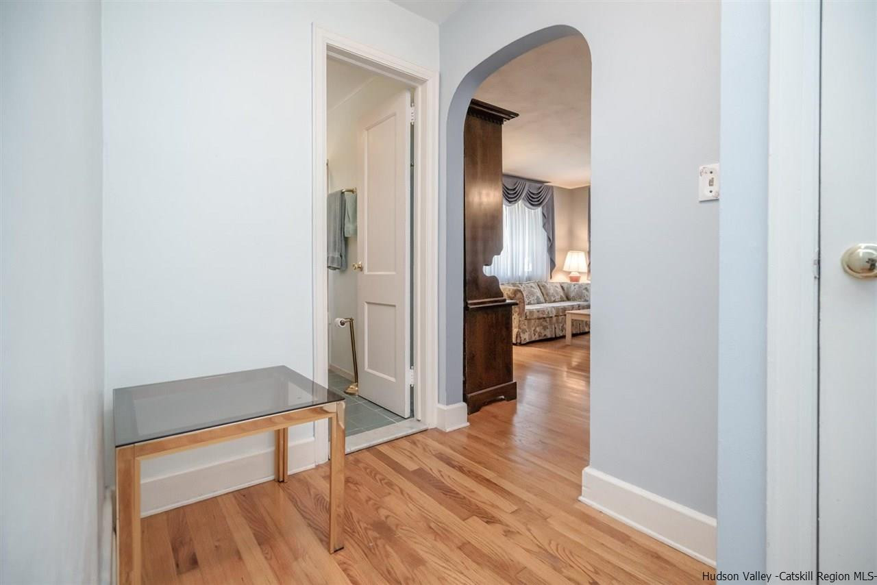 1034 Pine Place Kingston, NY 12401 - Photo 10 of 22 a view of a hallway with wooden floor and a bathroom