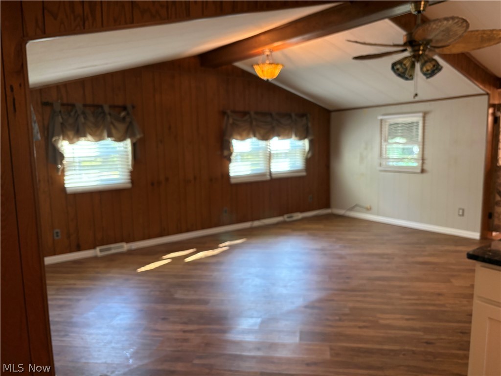 8701 Mayfield Road, Unit 148 Chesterland, OH 44026 - Photo 5 of 22 Living room with vaulted ceiling, ceiling light and fan, and new flooring