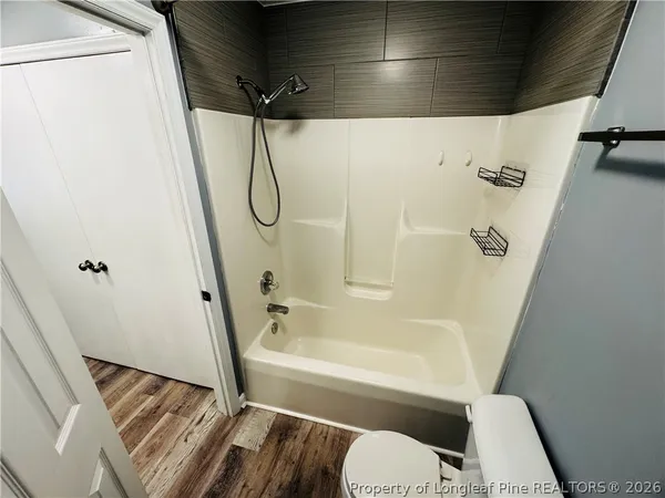 a bathroom with a tub and toilet