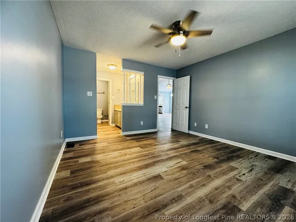 a view of empty room with ceiling fan