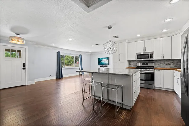 a kitchen with a stove a sink and a refrigerator