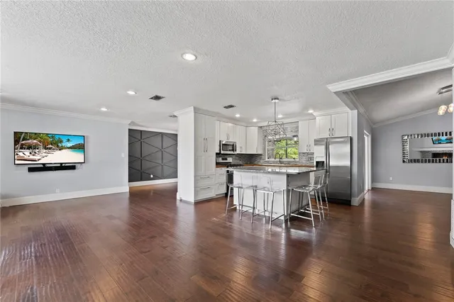 an open kitchen with white cabinets and stainless steel appliances
