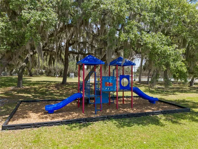 an aerial view of residential houses with outdoor space and lake view