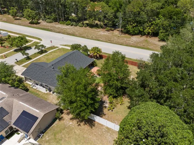 an aerial view of a house with a yard and lake view