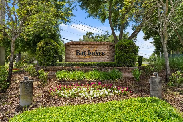 a sign that is sitting in front of flowers