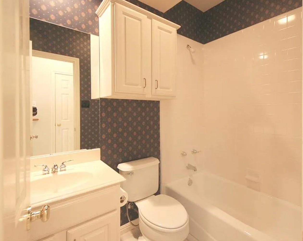 9405 Ashton Ridge Austin, TX 78750 - Photo 16 of 22 A compact bathroom offers a functional vanity with a sleek mirror and an adjoining tub/shower combination.