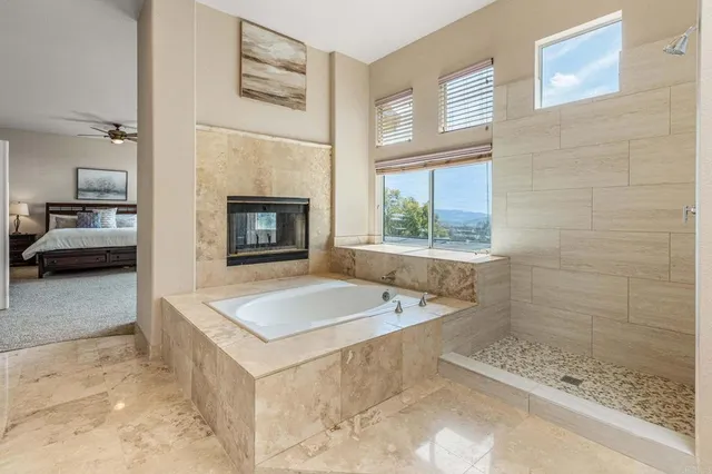 a bathroom with a tub sink and mirror