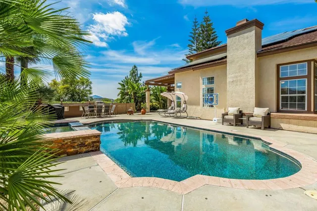 a view of a patio with table and chairs and potted plants
