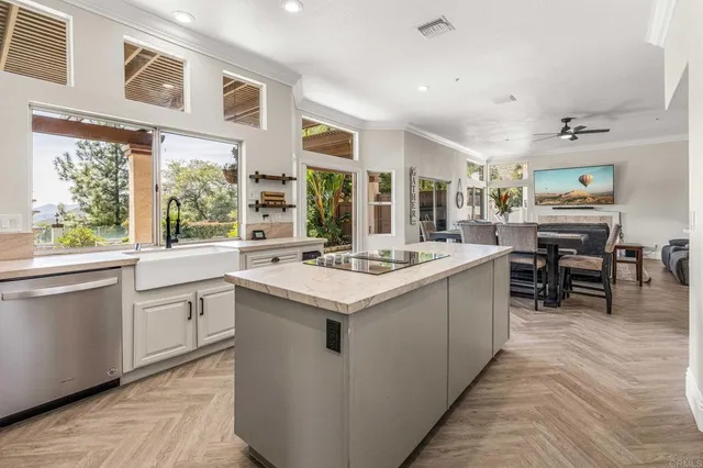 a kitchen with sink stove and cabinets