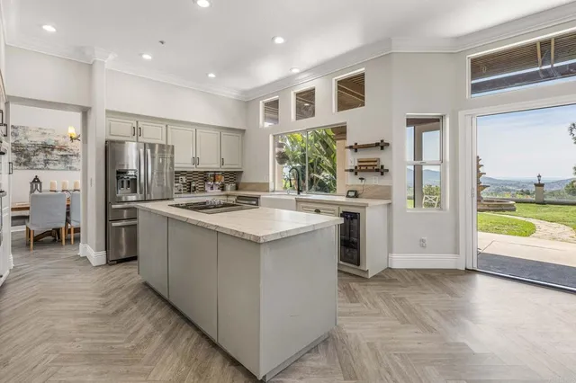 a kitchen with stainless steel appliances granite countertop a sink and a refrigerator