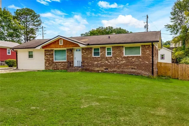 a front view of a house with a garden