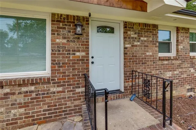 an empty room with wooden floor and mirror
