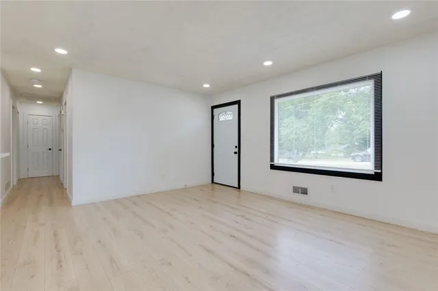 a kitchen with stainless steel appliances a sink stove and cabinets