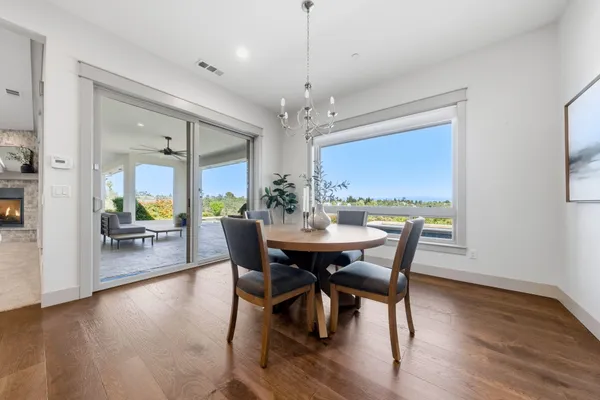 a view of a dining room with furniture wooden floor and chandelier
