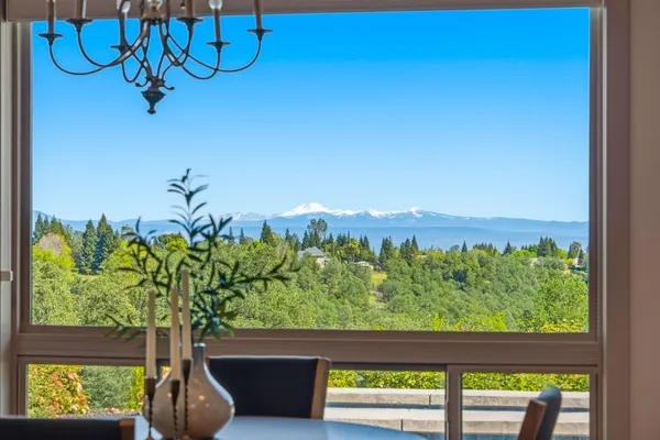 a vase of flowers sitting on a table with window