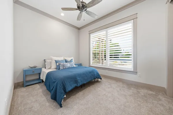 a spacious bedroom with a bed and window