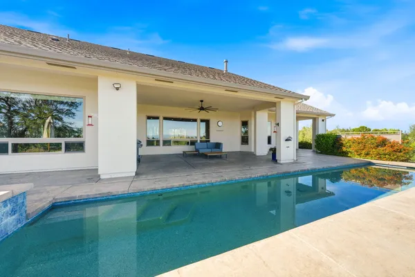a view of a swimming pool with a patio