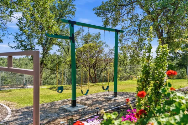 a view of a house with a backyard and a patio
