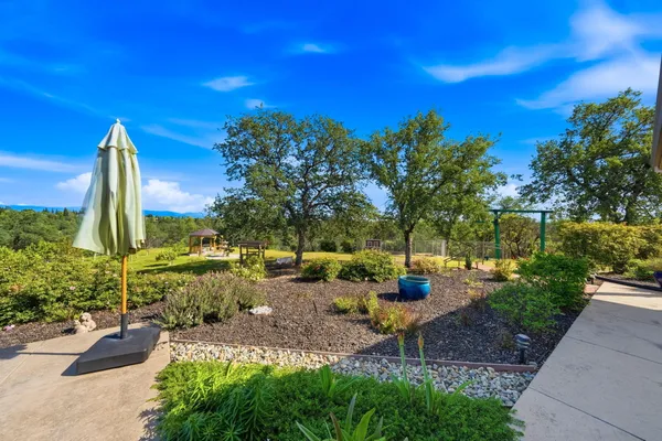 a view of a white house with a yard