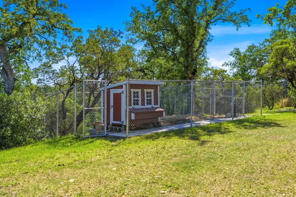 an aerial view of a house with garden space and street view