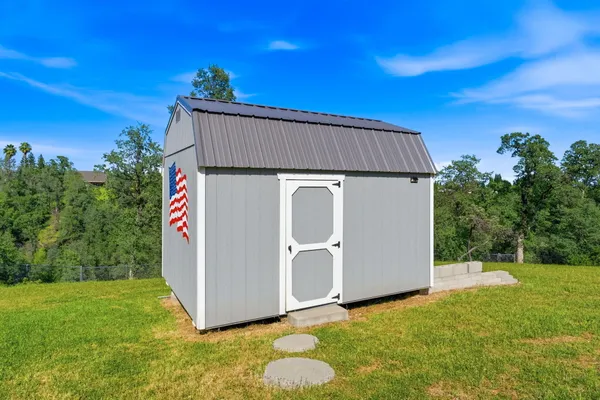 an aerial view of a house with a yard basket ball court and outdoor seating