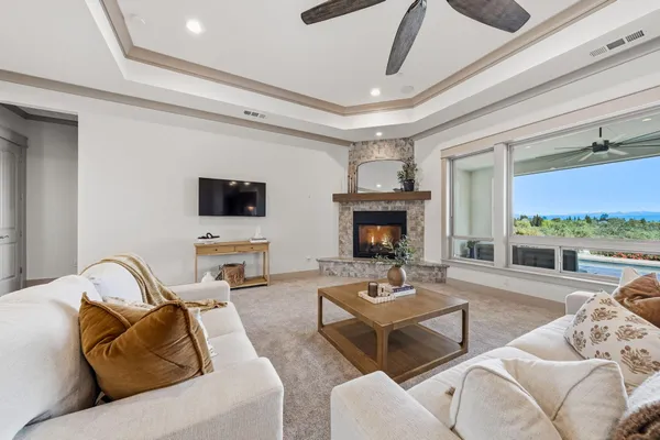 a living room with furniture a fireplace and a flat screen tv