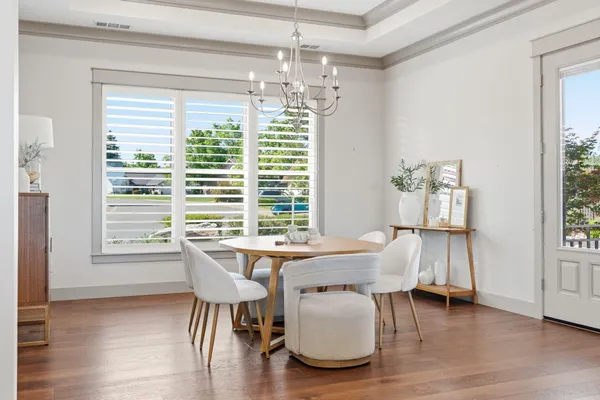 a dining room with furniture and wooden floor