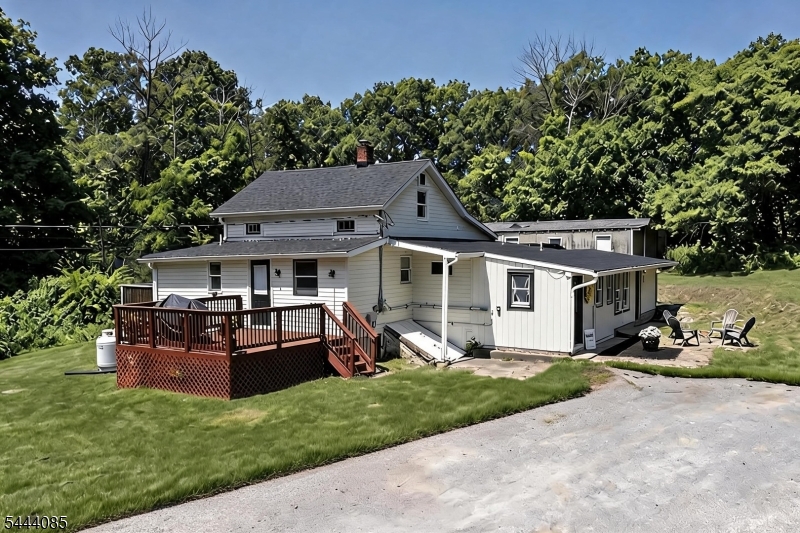 79 Lake Wallkill Road Vernon, NJ 07461 - Photo 1 of 27 a view of a house with backyard sitting area and garden