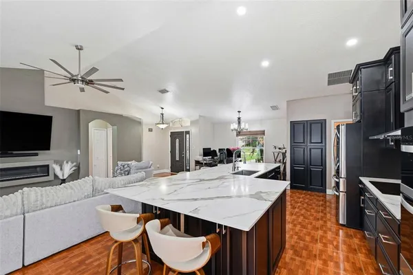 a kitchen with stainless steel appliances granite countertop a sink refrigerator and microwave