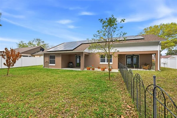 a view of a house with a backyard
