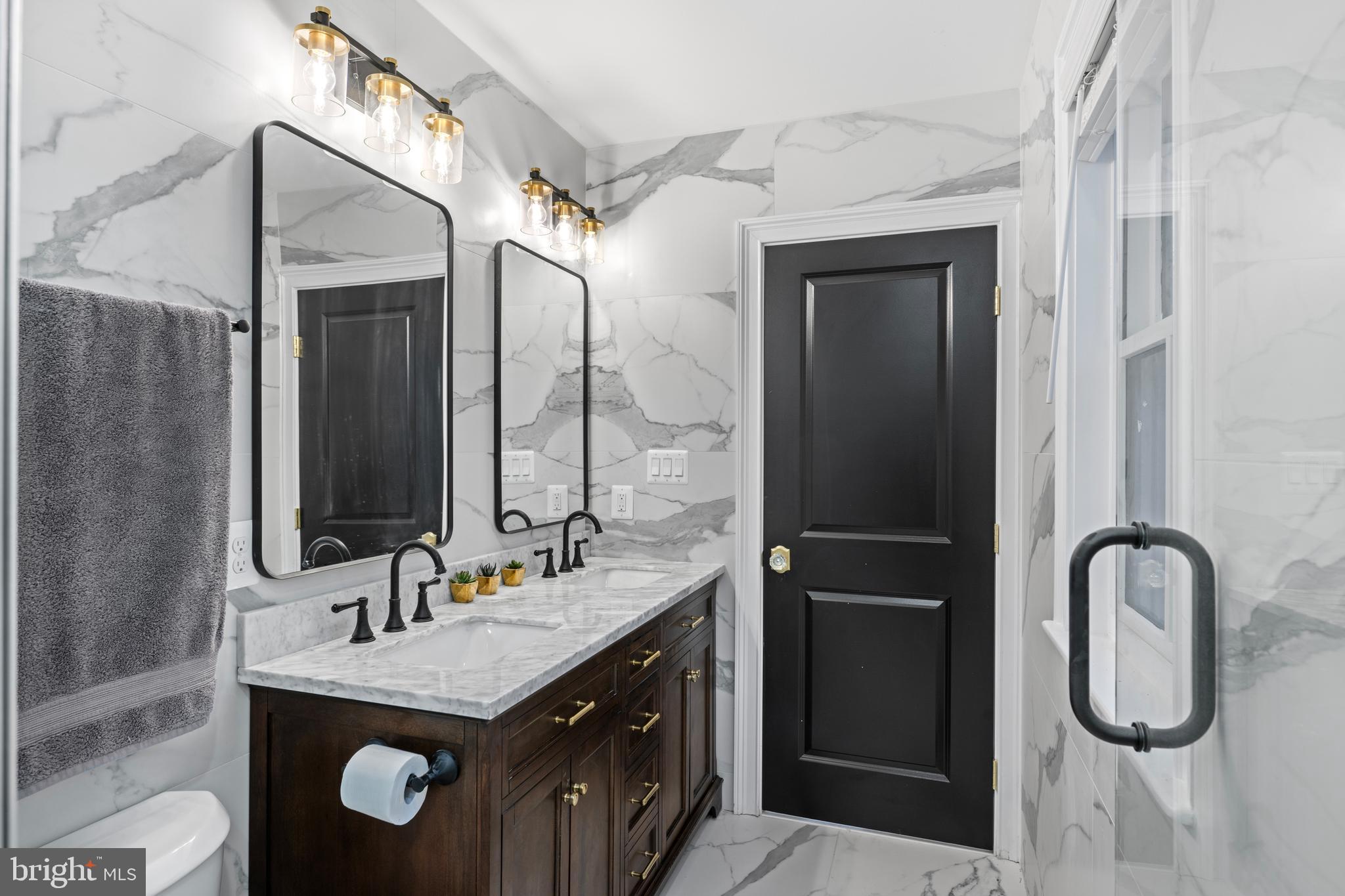 422 11th Street Southeast Washington, DC 20003 - Photo 37 of 51 a bathroom with a granite countertop sink vanity and mirror