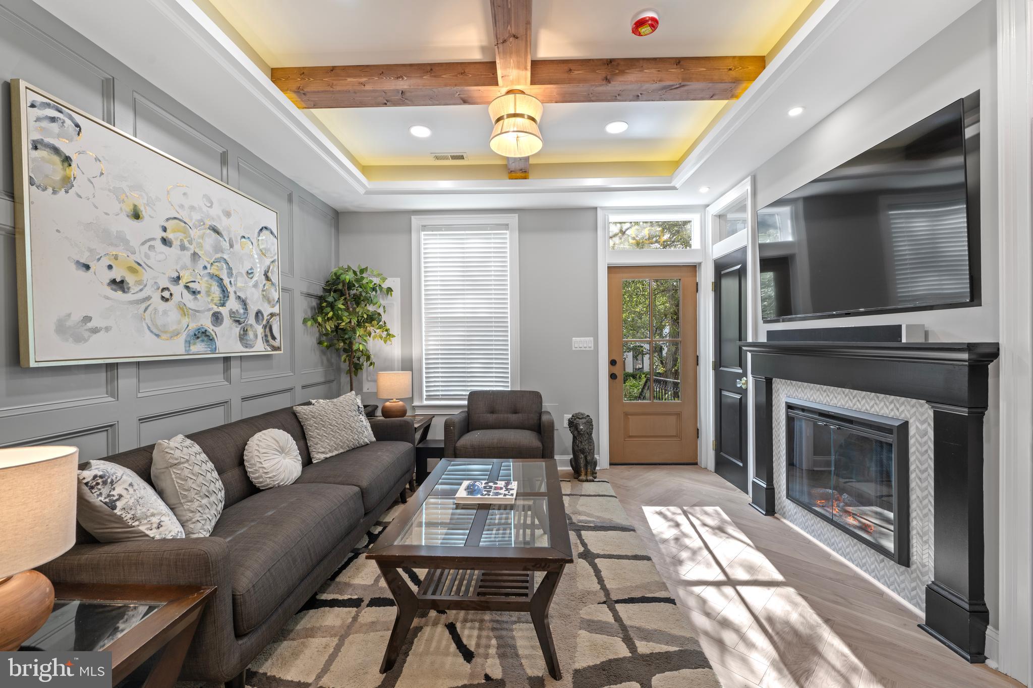 422 11th Street Southeast Washington, DC 20003 - Photo 6 of 51 a living room with furniture a fireplace and a flat screen tv