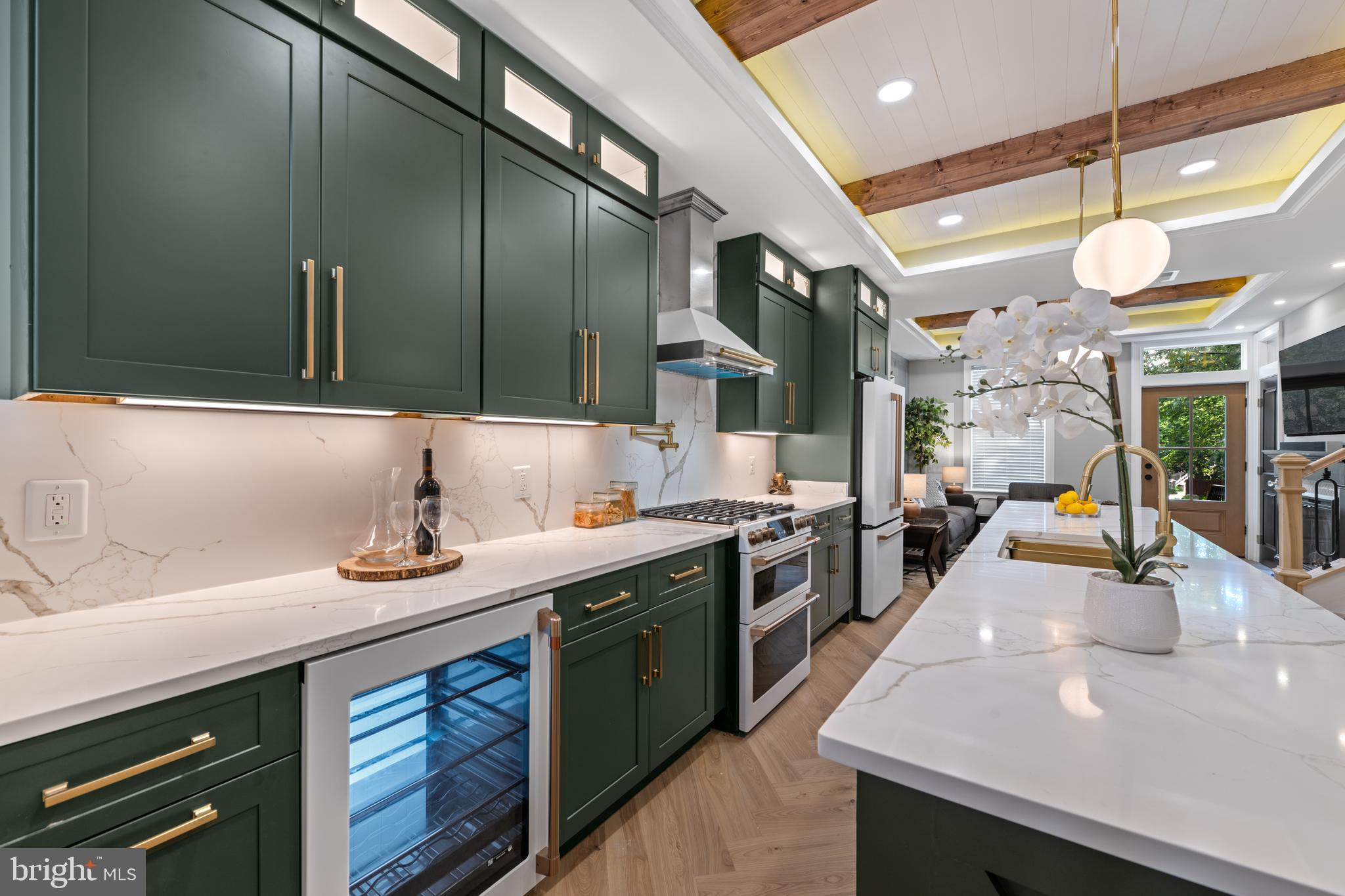 422 11th Street Southeast Washington, DC 20003 - Photo 9 of 51 a kitchen with stainless steel appliances a sink a stove and a wooden floor