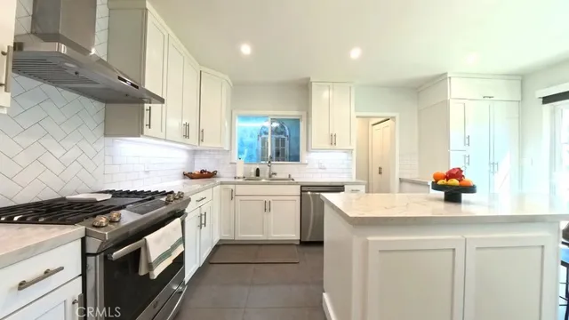 a kitchen with a sink stove and cabinets