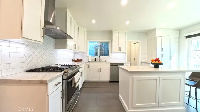 a kitchen with a sink stove and cabinets
