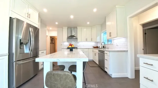 a kitchen with refrigerator a sink and cabinets