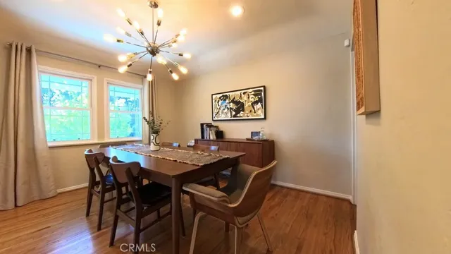 a view of a dining room with furniture and chandelier